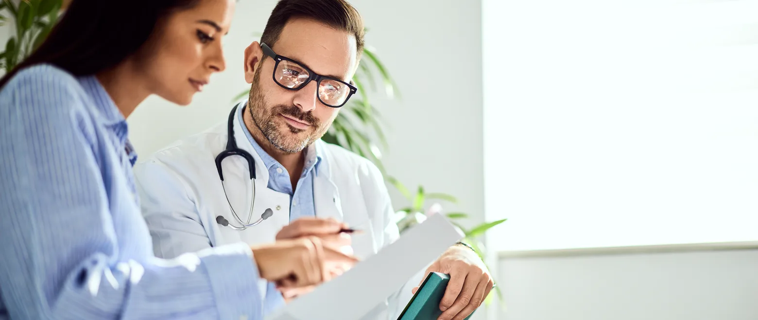 A patient and a clinician reviewing plan documents together