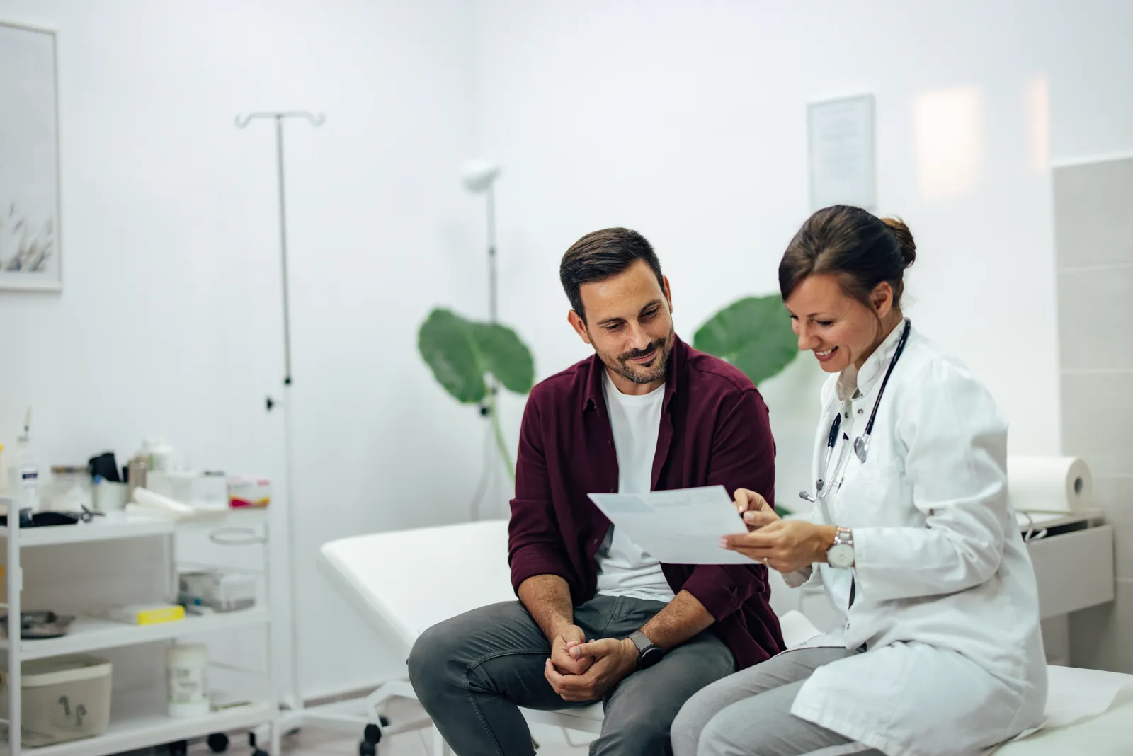A doctor showing documents to a patient in a medical office