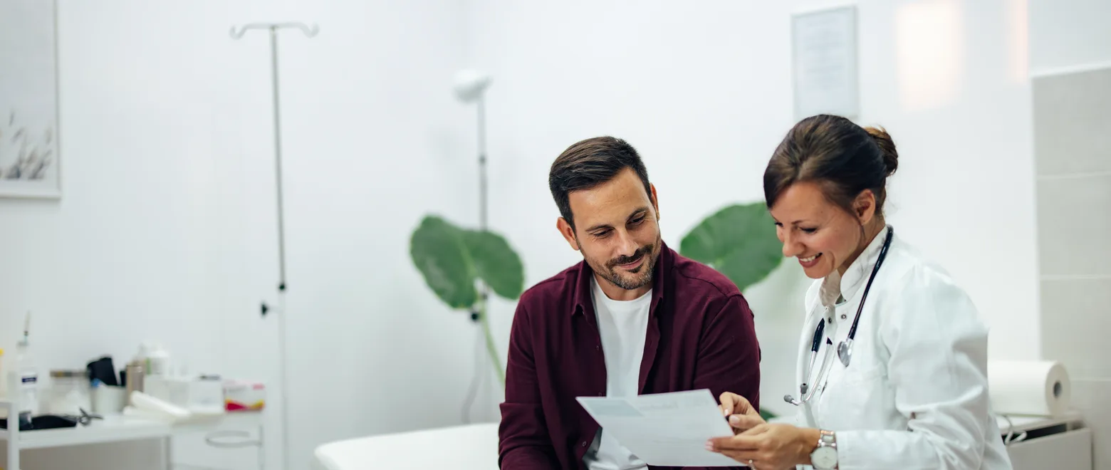 A patient and a clinician reading a statement together in a consulting room