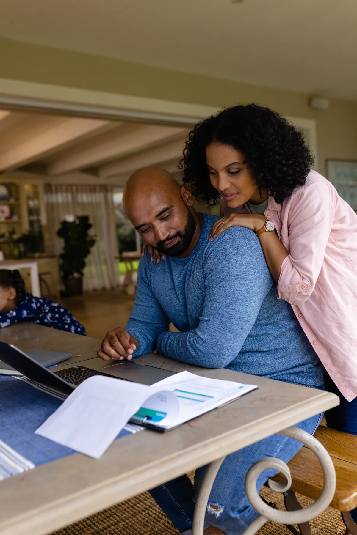 A couple reviewing health plan documents together at home